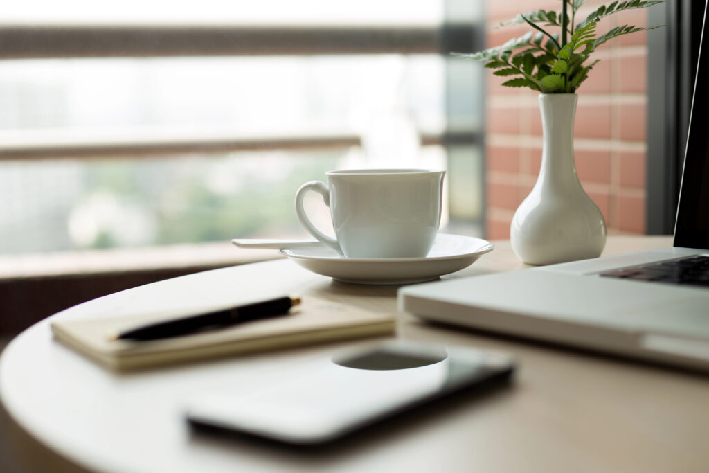 Depositphotos_171844732_XL office working space with notebooks and phone window view