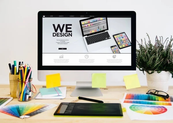 desktop showing a design interface and office materials